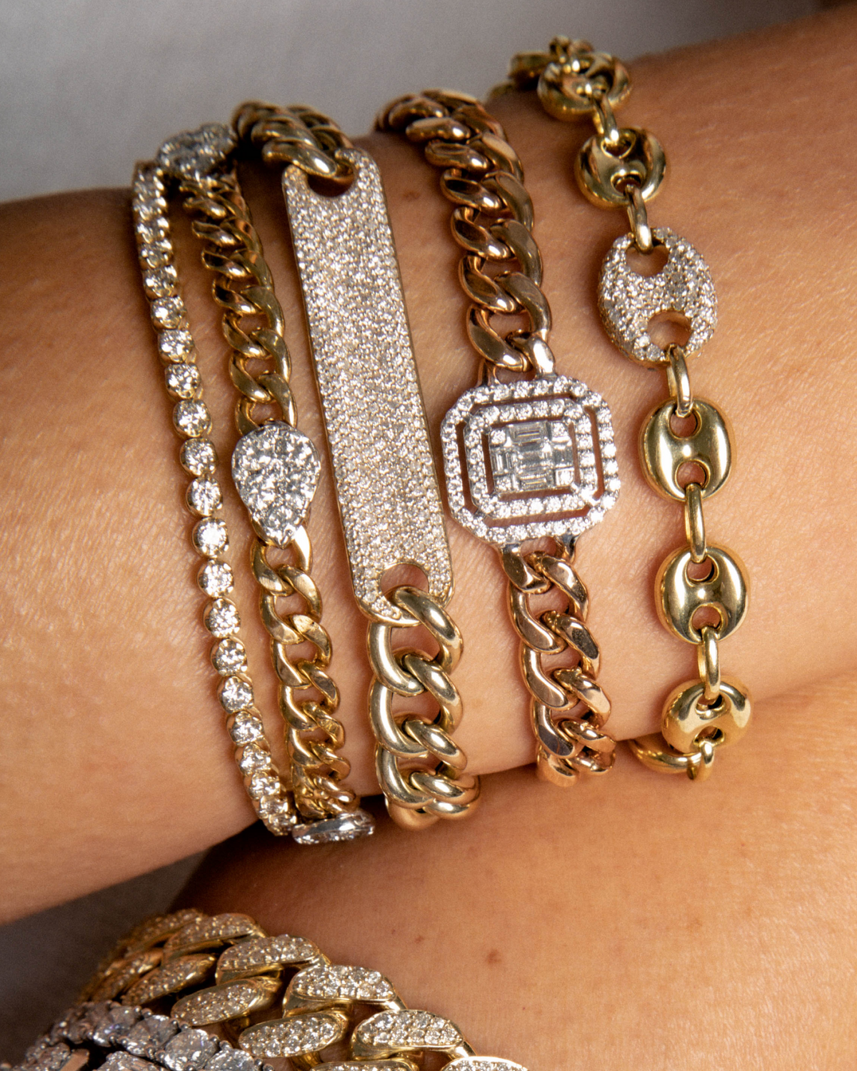 Gold and silver bracelets on a wrist